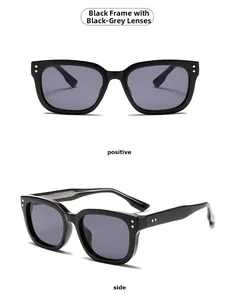 Detail of square black frame sunglasses with dark grey lenses and silver rivets