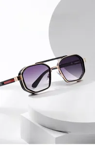 Detail of square black and gold sunglasses with purple gradient lenses on white blocks