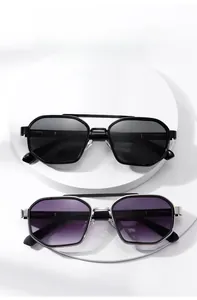 Close-up of retro metal sunglasses with black frames and purple gradient lenses