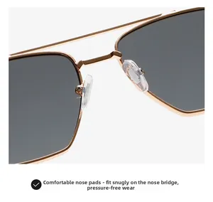 Detail of comfortable silicone nose pads on gold metal sunglasses with dark lenses