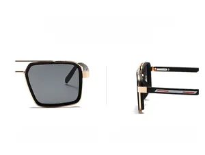 Close-up of retro narrow frame sunglasses showing black and gold temples and hinges
