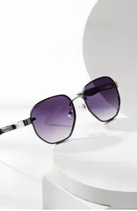 Close-up of purple gradient lenses and silver metal hollowed-out temple design on sunglasses