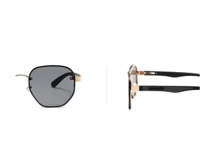 Detail view of narrow retro sunglasses with gold metal frame and dark grey lenses
