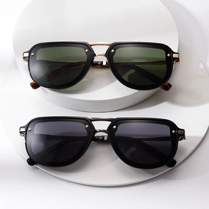 Modern pilot sunglasses with metallic studs and double bridge in black and gold finish