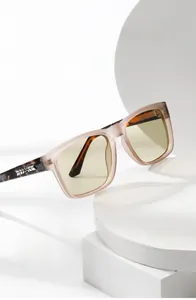 Detail of vintage square sunglasses with champagne frames and tortoise temples on steps