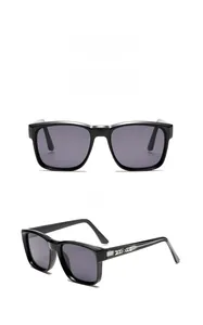 Detail of square black sunglasses with silver arrow temple décor and gray lenses