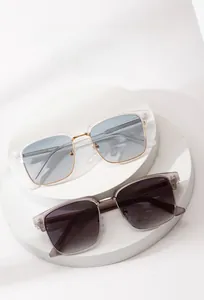 Detail of square oversized sunglasses with gradient lenses and gold metal nose bridge
