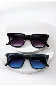 Top view of square sunglasses with star accents on a white tiered podium