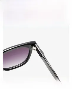 Detail of square sunglasses with black frame, purple gradient lenses and metal hinges