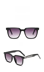 Detail of black square sunglasses featuring silver cross metal accents on the temples