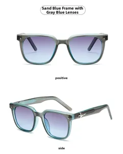 Detail of matte blue square sunglasses with grey-blue gradient lenses and silver star accents