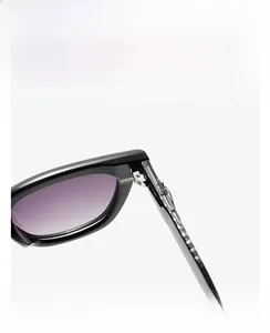 Macro detail of high-quality metal hinge on bold black square sunglasses with purple lenses
