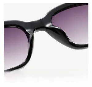 Close-up of square sunglasses with purple gradient lenses and integrated nose pads