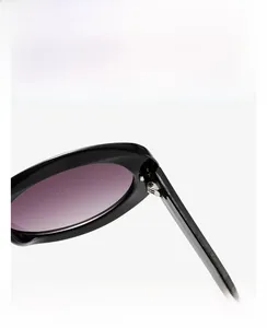 Detail shot of the sturdy hinge connecting the black frame and purple gradient lens