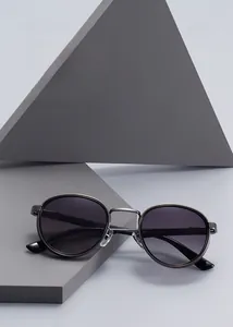 Macro shot of gunmetal sunglasses frame with gradient lenses on geometric display