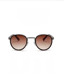 Detailed view of round metal sunglasses with vintage brown gradient lenses and thin frames