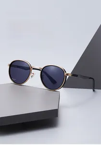 Detail of vintage gold metal sunglasses with black lenses and carbon fiber texture temples