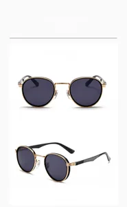 Detail view of round retro metal sunglasses with gold frames and dark grey lenses