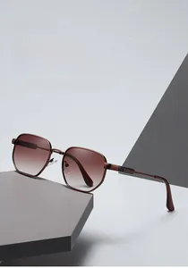 Detailed macro view of trendy polygon metal sunglasses with brown gradient lenses