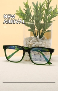 Detail of dark green tortoise eyeglass frame featuring durable metal hinges and texture