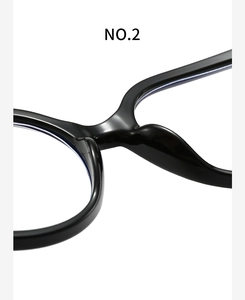 Macro view of black acetate frame showing the integrated nose pad and bridge structure