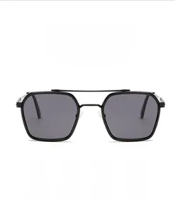 Close-up of sleek black metal double-bridge sunglasses with polarized gray lenses