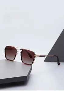 Detail of retro narrow gold metal frame sunglasses with brown gradient lenses