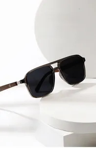 Detail of polarized round sunglasses with translucent grey frame and wood grain temples