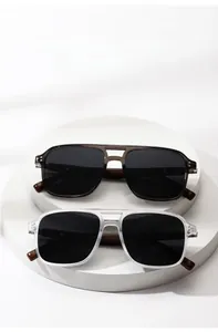 Detail of round polarized sunglasses with walnut wood temples and metal rivets decoration