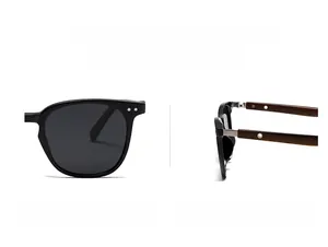 Detail of retro polarized sunglasses with black frame and wood grain temples featuring silver studs