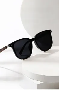 Detail of wooden texture and metal hinge on black round polarized sunglasses frame