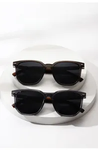 Macro detail of round polarized sunglasses with translucent frames on display stands