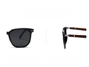 Detail of round polarized sunglasses with black frames and dark wood grain temples