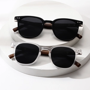 Classic square polarized sunglasses with textured wooden arms on white pedestals