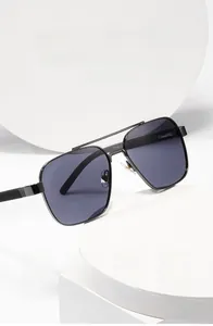 Detail view of double bridge aviator sunglasses with matte black frames and dark gray lenses