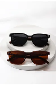 Detail view of square polarized sunglasses featuring wood grain temples and metal rivets