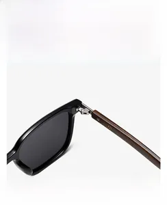 Macro shot of polarized sunglasses featuring wooden grain temples and metal hinges