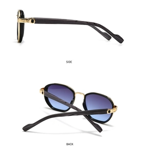 Detail of vintage cat-eye sunglasses with gold metal hinges and dark wood grain temples