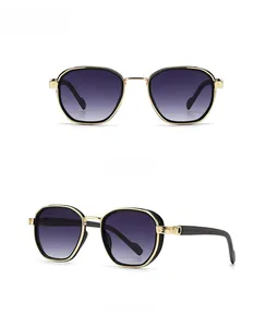 Detail of retro gold metal frame sunglasses with screw motif hinge and gradient lenses