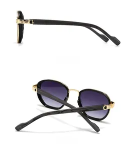 Detail of vintage square sunglasses with gold metal hinges and purple gradient lenses