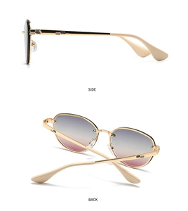 Detail view of gold metal sunglasses with gradient lenses and honeycomb temples