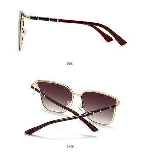 Detail of vintage gold metal sunglasses with bamboo-style temples and gradient lenses