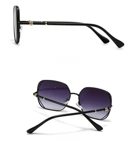 Side and back view of narrow sunglasses with metal frame and gold circle accents