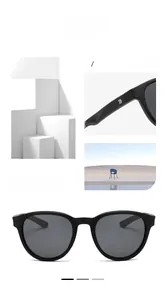 Detail view of round matte black sunglasses featuring polarized lenses and temple logos