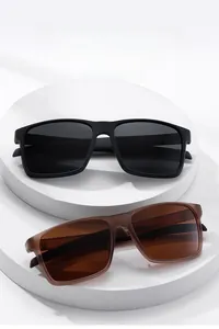 Detailed shot of large square polarized sunglasses in matte black and translucent tea brown
