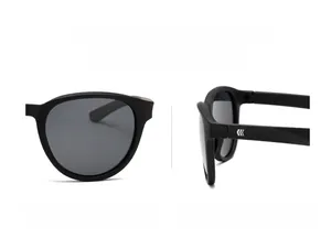 Detail view of matte black TR polarized sunglasses with geometric logo on temple arm