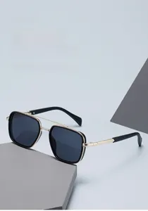Detail of trendy narrow black square sunglasses with gold metal double bridge design