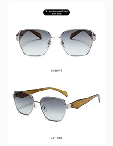 Detail view of narrow metal sunglasses with light blue gradient lenses and tortoiseshell arms