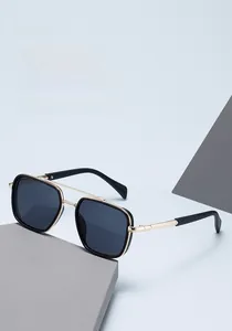 Detail of trendy square sunglasses with black frame, double bridge and gold metal accents