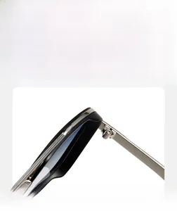 Detail view of durable silver metal hinges on retro narrow frame sunglasses